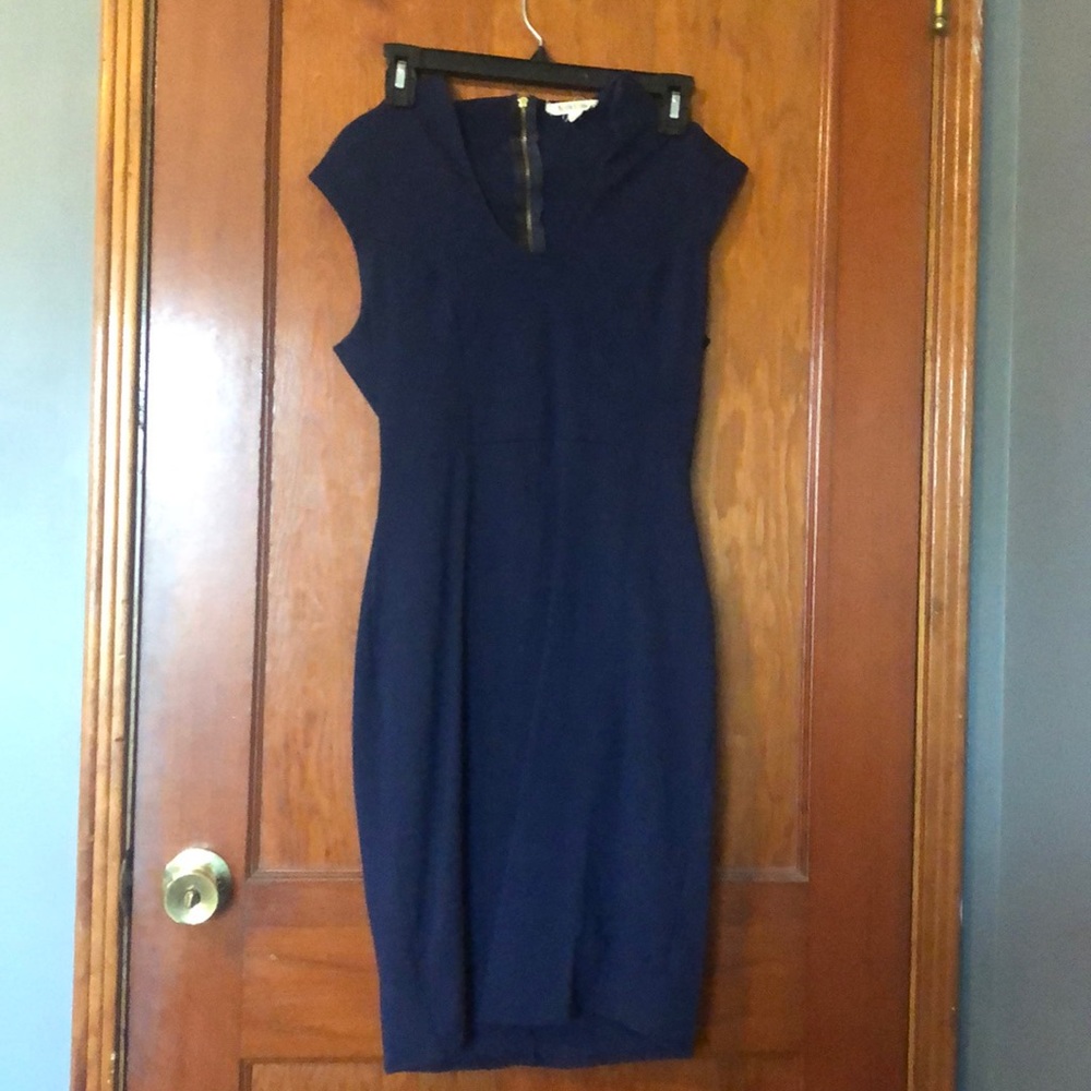 Form fitted navy blue dress with popped collar